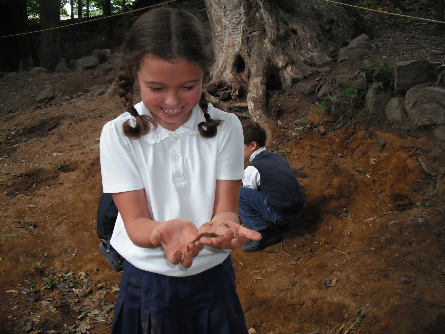 Student Playing with Worm outdoors at The Imago School Maynard MA