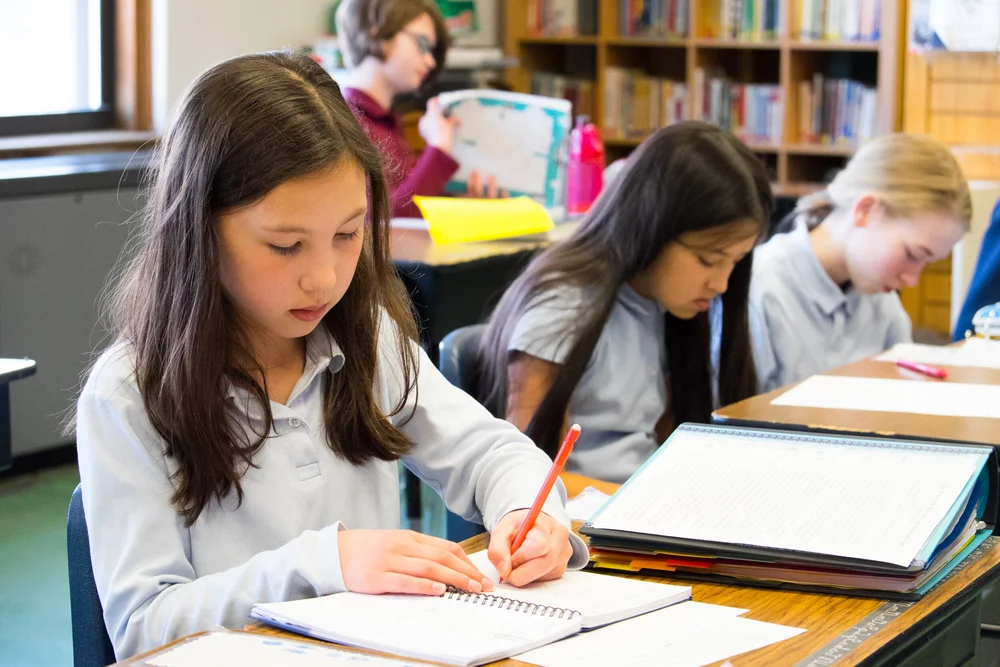 Students working at a desk at The Imago School in Maynard MA