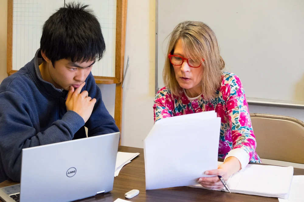 Student getting help from a teacher at The Imago School 